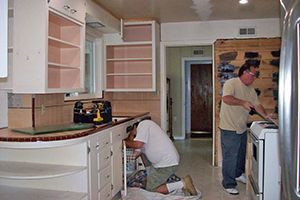 people working in a kitchen remodel