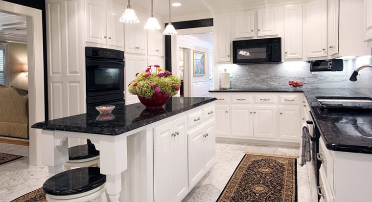 white kitchen with dark granite countertops