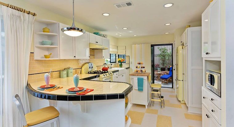 colorful kitchen with yellow quartz countertops and black-and-white checked floor