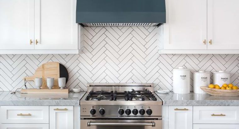 white countertops and cabinets with light gray mosaic tile full backsplash and retro style refrigerator